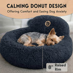 Dog lying on a dark blue donut-shaped pet bed with text about calming design and comfort.