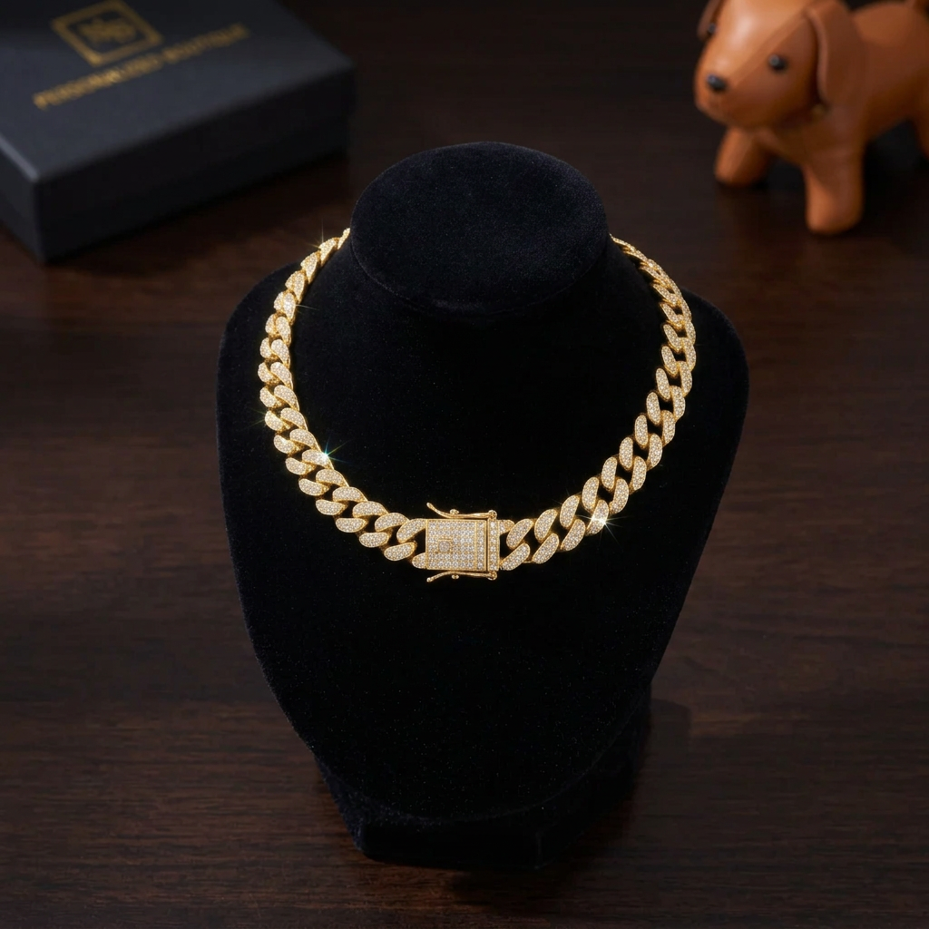 A gold Cuban link chain necklace heavily embellished with clear rhinestones, displayed on a textured black background.